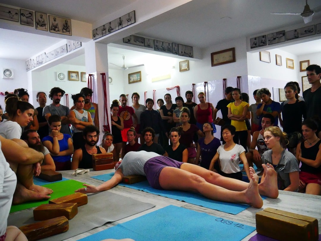 Teaching Yoga Supta Tadasana with props in Rishikesh, India