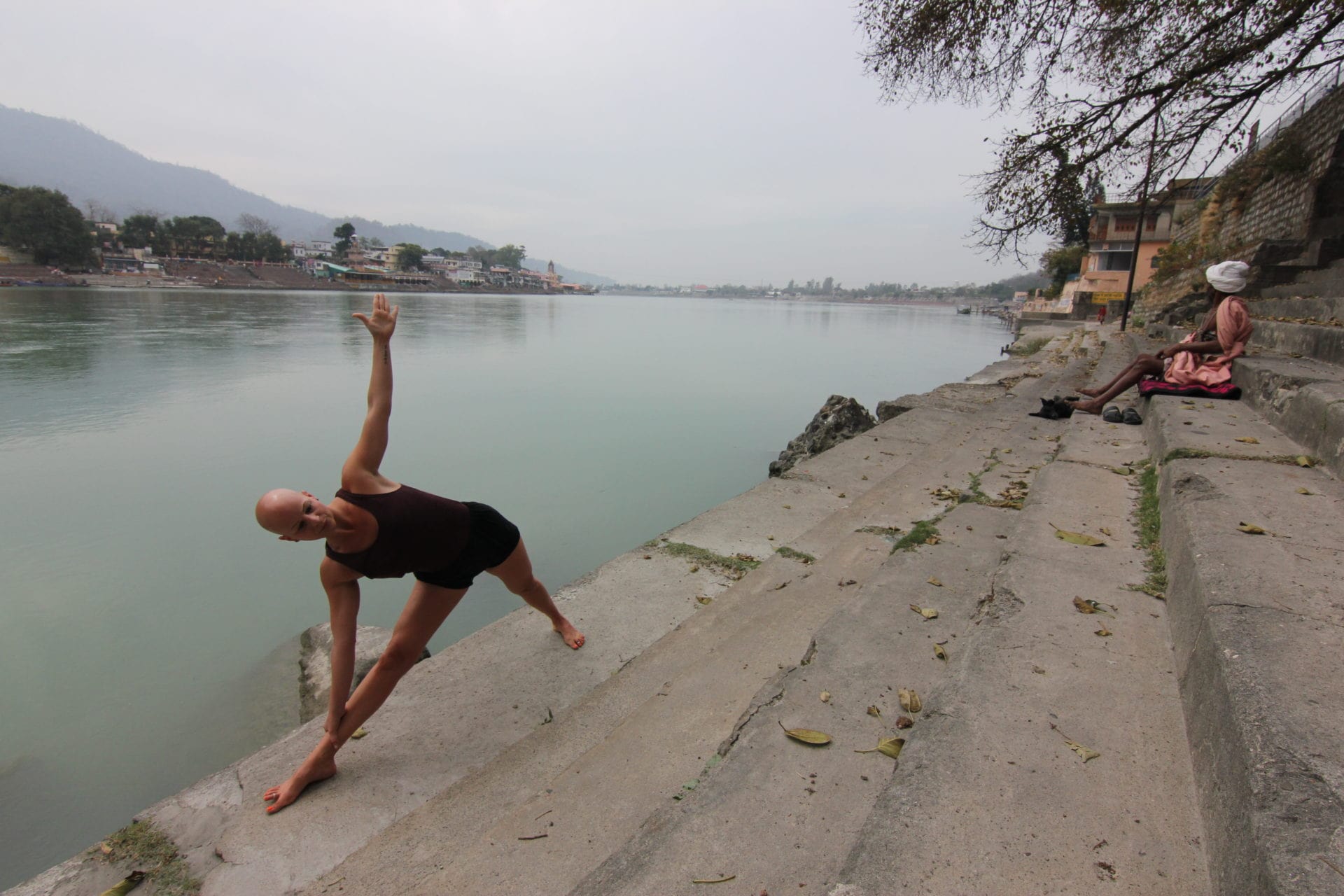 Yoga Utthita Trikonasana, extended Triangle Final Pose, by the Ganges in Rishikesh, India